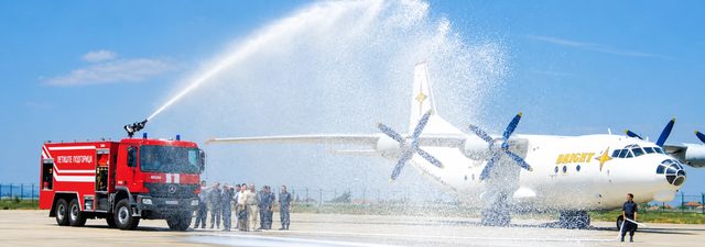 BULFIRE airport fire-fighting vehicle spraying water over an aircraft